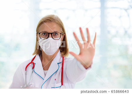 Doctor or nurse with stethoscope and face mask. Doctor or nurse with stethoscope and face mask. 65866643