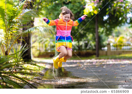 Kids in puddle in autumn rain. Waterproof wear 65866909
