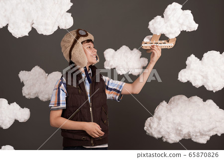 a boy plays with a cardboard airplane and dreams a boy plays with a cardboard airplane and dreams 65870826