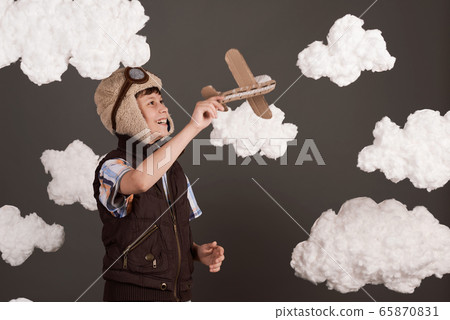 a boy plays with a cardboard airplane and dreams a boy plays with a cardboard airplane and dreams 65870831