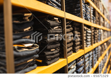 shelf with denim pants for sale in a boutique shelf with denim pants for sale in a boutique 65871329