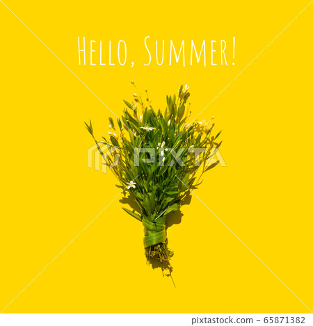 Delicate bouquet of little flowers on a yellow background. Flat lay summer concept Delicate bouquet of little flowers on a yellow background. Flat lay summer concept 65871382