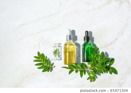 Serum with herbal extracts for skincare. Flat Lay minimalism 65871504