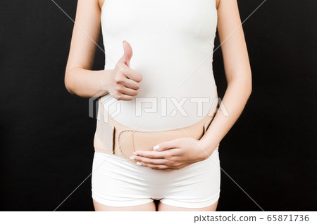 Close up of pregnant woman wearing pregnancy Close up of pregnant woman wearing pregnancy 65871736