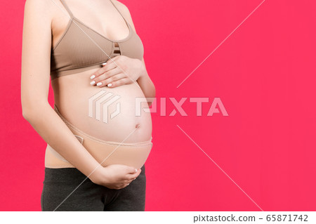 Close up of pregnancy bandage dressed on pregnant 65871742