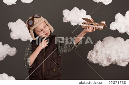 a girl plays with a cardboard airplane and dreams a girl plays with a cardboard airplane and dreams 65871788