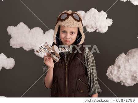 a girl plays with a cardboard airplane and dreams a girl plays with a cardboard airplane and dreams 65871799