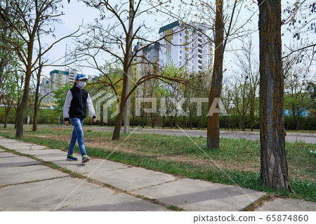 child girl walks down the street during the day, a 65874860