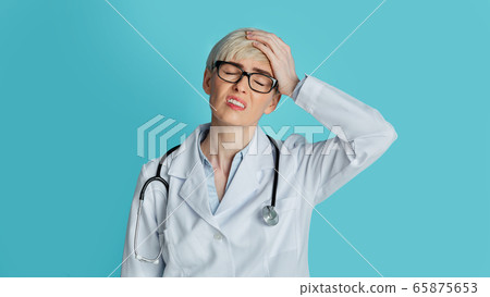 Forgotten and confused concept. Upset doctor closes eyes and press hand to head 65875653