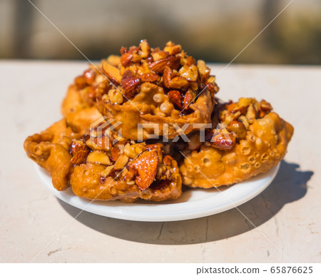 Cartellate Pugliesei italian traditional food from Puglia region named crispy puff pastry with honey 65876625