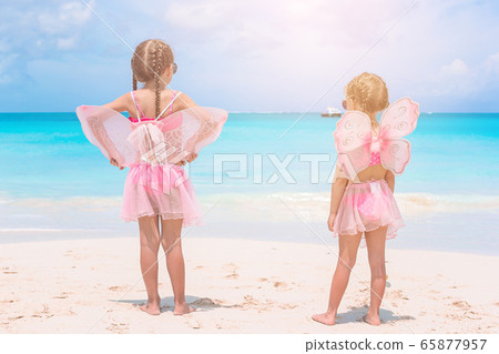 Adorable little girls have a lot of fun on the beach. Adorable little girls have a lot of fun on the beach. 65877957