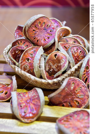 Slices of Bael fruit, matum, for tea and ingredient of food. Slices of Bael fruit, matum, for tea and ingredient of food. 65877958