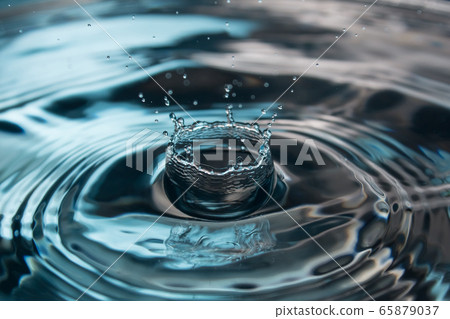 Water splash close-up. Drop of water. Blue water drop. Falling water. blue water surface with splash and air bubbles. 65879037