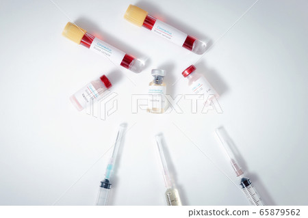 Top view of vaccine, blood samples in tubes and syringes on work table. 65879562