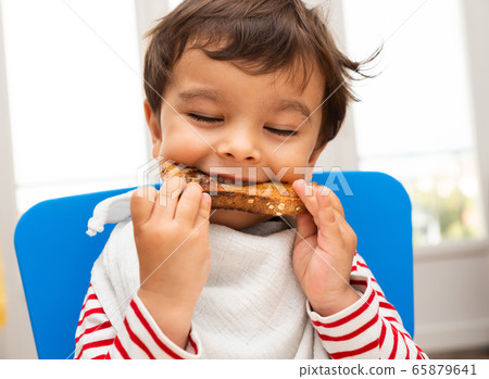 Toddler eating a toast Toddler eating a toast 65879641