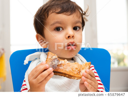 Toddler eating a toast 65879647