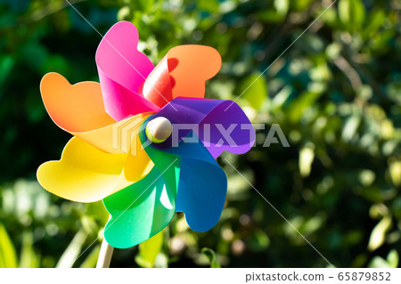 Colorful toy plastic turbine windmill on green background 65879852