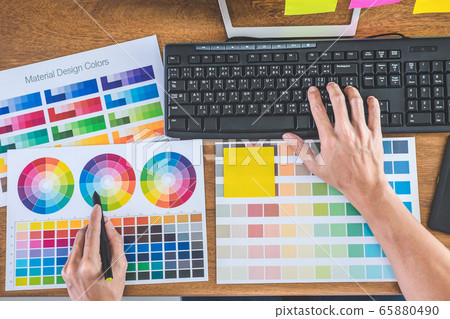 Image of male creative graphic designer working on 65880490
