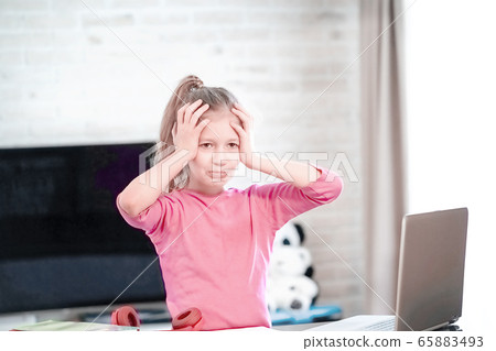 Emotional portrait of schoolgirl studying homework, home schooler Emotional portrait of schoolgirl studying homework, home schooler 65883493