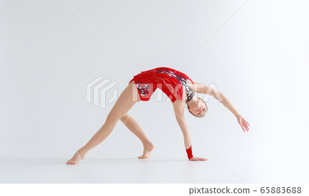 Rhythmic gymnastics practice. Flexible girl doing backbend exercise, isolated on white 65883688
