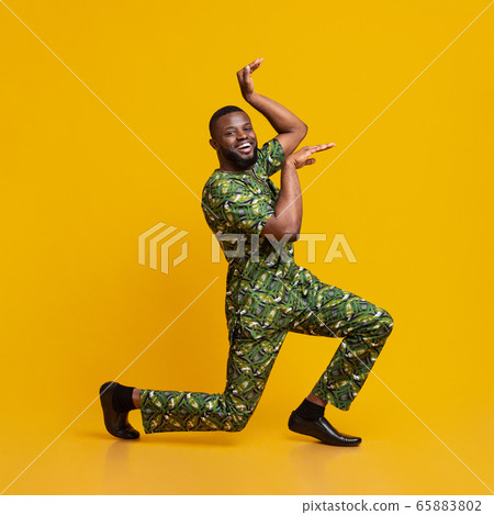 Funny black guy fooling over yellow background Funny black guy fooling over yellow background 65883802