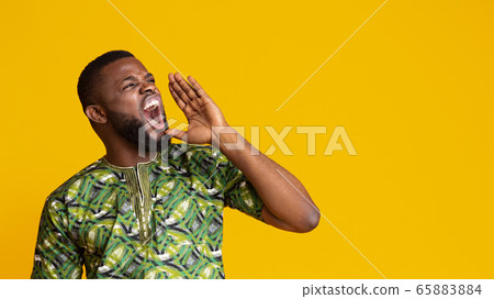 Emotional black guy shouting towards copy space Emotional black guy shouting towards copy space 65883884