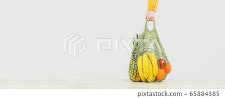 Grocery. Hand holds shopper with fruits and 65884385