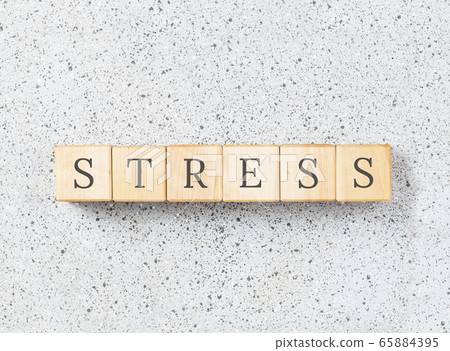 Stress word made with wooden blocks on grey Stress word made with wooden blocks on grey 65884395