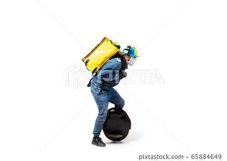 Too much orders. Contacless delivery service during quarantine. Man delivers food and shopping bags during isolation, wearing gloves and face mask. Too much orders. Contacless delivery service during quarantine. Man delivers food and shopping bags during isolation, wearing gloves and face mask. 65884649