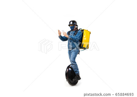 Too much orders. Contacless delivery service during quarantine. Man delivers food and shopping bags during isolation, wearing gloves and face mask. Too much orders. Contacless delivery service during quarantine. Man delivers food and shopping bags during isolation, wearing gloves and face mask. 65884693