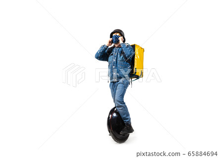 Too much orders. Contacless delivery service during quarantine. Man delivers food and shopping bags during isolation, wearing gloves and face mask. Too much orders. Contacless delivery service during quarantine. Man delivers food and shopping bags during isolation, wearing gloves and face mask. 65884694