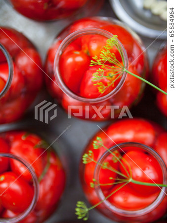 Pickling (canning) the tomatoes. Pickling (canning) the tomatoes. 65884964