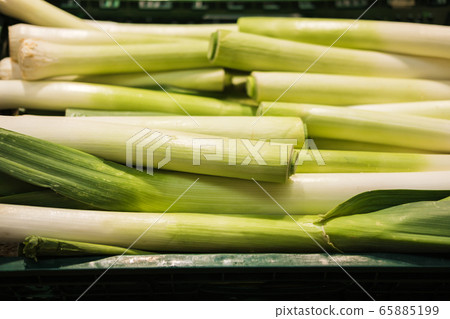 Banner of fresh leeks on the counter in the supermarket, market, greengrocery. Banner of fresh leeks on the counter in the supermarket, market, greengrocery. 65885199