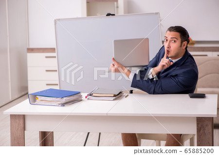 Young male employee working at home during pandemic disease Young male employee working at home during pandemic disease 65885200