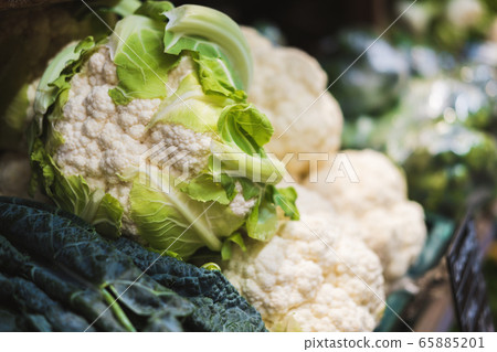 Banner of fresh cauliflower on the counter in a supermarket, market, greengrocery. Banner of fresh cauliflower on the counter in a supermarket, market, greengrocery. 65885201