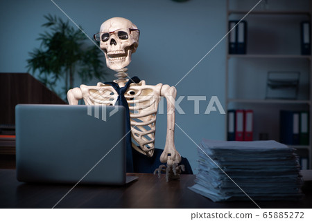 Young male employee working in the office night time Young male employee working in the office night time 65885272