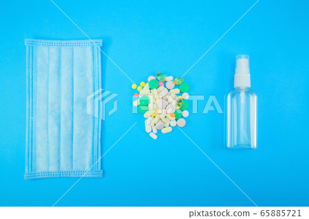 Hygienic face mask, medical drugs, Alcohol gel Sanitizer hand gel cleaners for anti Bacteria and virus on blue Background 65885721