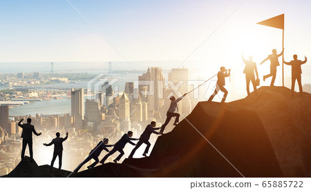 Concept of teamwork with team climbing mountain top 65885722