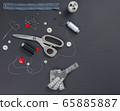 sewing items on a black background from above 65885887
