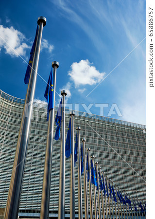 EU European Union flags in front of European Comission building in Background. Brussles, Belgium EU European Union flags in front of European Comission building in Background. Brussles, Belgium 65886757