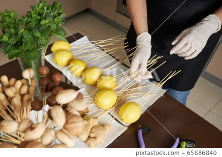 Woman is preparing to create a beautiful fruit bouquet 65886840