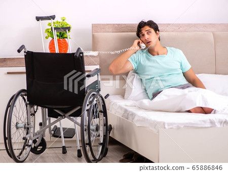 Young handsome disabled man recovering at home Young handsome disabled man recovering at home 65886846