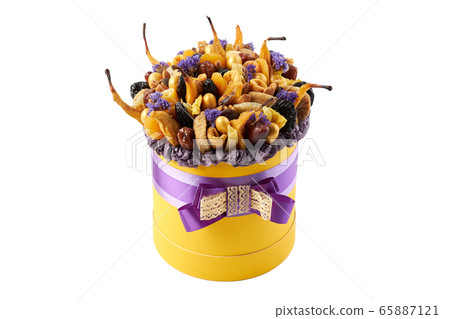 Yellow cylindrical box filled with dried fruits Yellow cylindrical box filled with dried fruits 65887121