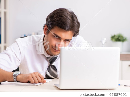 Young handsome businessman working in office 65887691