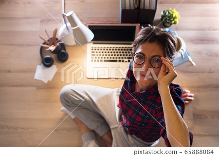 Happy woman lying floor and working on computer Happy woman lying floor and working on computer 65888084