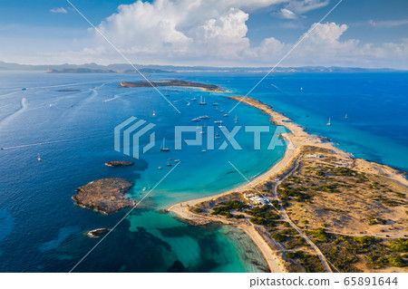 Aerial view over the clear beach and turquoise water of Formentera, Ibiza. Aerial view over the clear beach and turquoise water of Formentera, Ibiza. 65891644