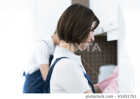 Housekeeping men and women cleaning the kitchen 65891761