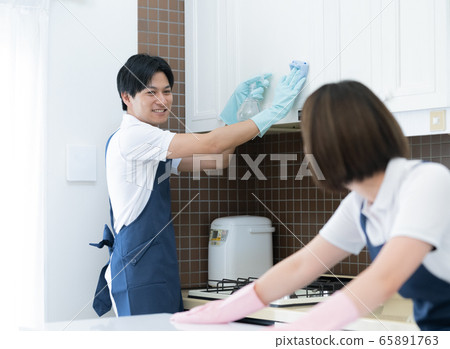 Housekeeping men and women cleaning the kitchen 65891763