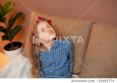 Young girl sitting on bed in the bedroom 65891774