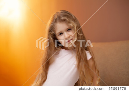 Young girl sitting on bed in the bedroom Young girl sitting on bed in the bedroom 65891776